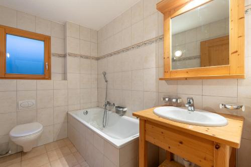Un baño con lavabo, bañera e inodoro. en Plein Ciel VA 013 - MOUNTAIN apartment 8 pers, en Veysonnaz