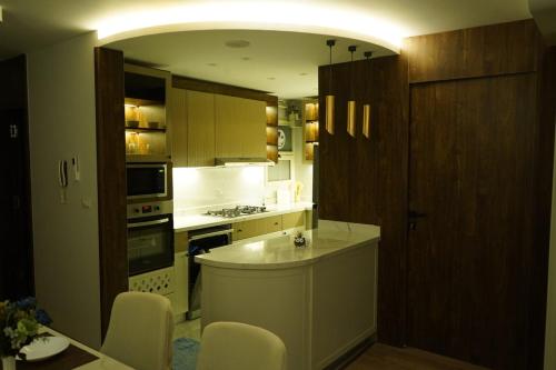 a kitchen with a counter and a stove top oven at kornfil guest house in New cairo