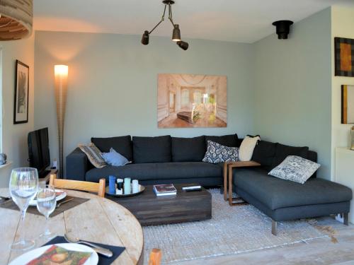 a living room with a couch and a table at Holiday Home in Noordwijk near the Beach in Noordwijk