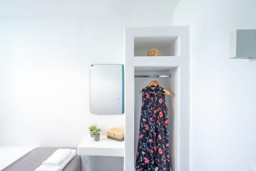 a dress hanging on a shelf in a room at Depis private villas Plaka Naxos in Plaka