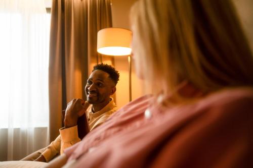 a man is brushing his teeth in front of a mirror at Clayton Hotel Galway in Galway