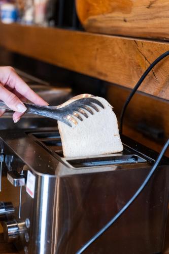 a person using a spatula to cut a cake at Sundial Boutique Hotel in Zagreb