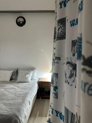 a bedroom with a bed and a window with a curtain at Amazing Two-Bedroom Apartment in Residence Lukomorye D5 with scenic view in Karavas