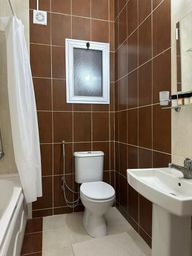 a bathroom with a toilet and a sink at Amazing Two-Bedroom Apartment in Residence Lukomorye D5 with scenic view in Karavas