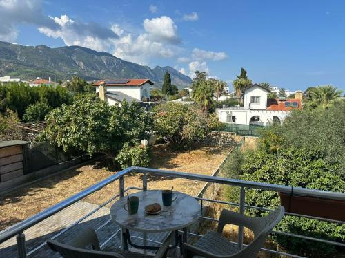 a patio with a table and chairs on a balcony at Amazing Two-Bedroom Apartment in Residence Lukomorye D5 with scenic view in Karavas