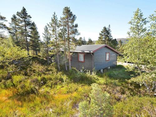 a house in the middle of a field with trees at 6 person holiday home in ÅSERAL-By Traum in Hamkoll