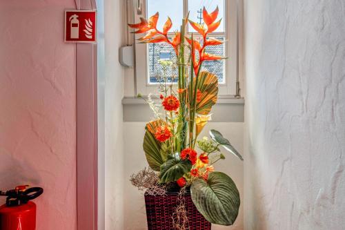 a vase filled with flowers in a window at Landhaus Christophorus in Forbach