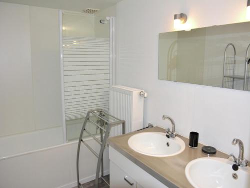 a bathroom with two sinks and a shower at Vintage Farmhouse with Garden, Roofed Terrace in Gouvy