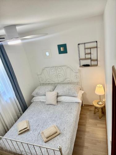 a bedroom with a bed with a white bedspread at Summer app Pool Spa jacuzzi 2 in Makarska