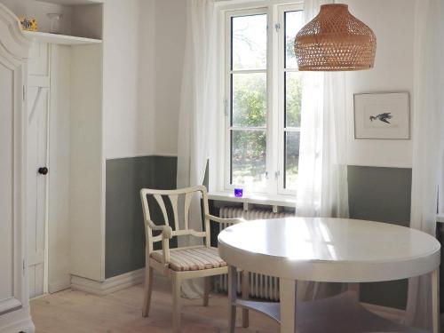 a dining room with a table and chairs and a window at 20 person holiday home in Ulfborg in Ulfborg