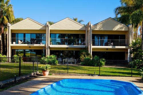 a house with a swimming pool in front of it at Elsinor Townhouse 1 in Mulwala