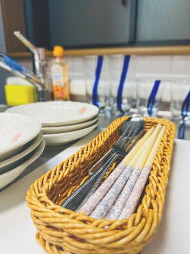 a basket with utensils in it on a counter at 4min to 東新宿Shinjuku in Tokyo