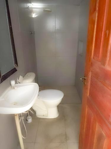a bathroom with a toilet and a sink at Pedro Teixeira House in Belém