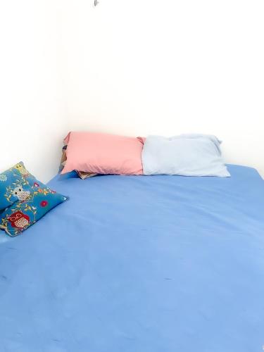 a bed with two pillows on top of it at Pedro Teixeira House in Belém