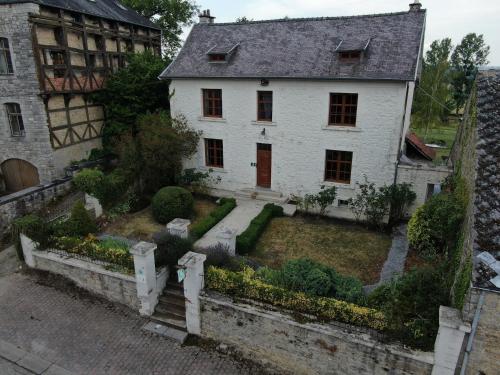 an old white house with a garden in front of it at Cozy Escape in Namur Region in Doische