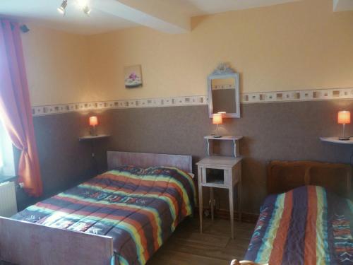 a bedroom with two beds and a tv on the wall at Cozy Escape in Namur Region in Doische