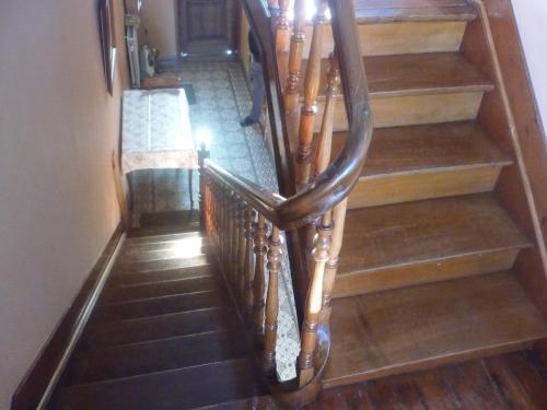 a staircase with wooden railings in a house at Cozy Escape in Namur Region in Doische