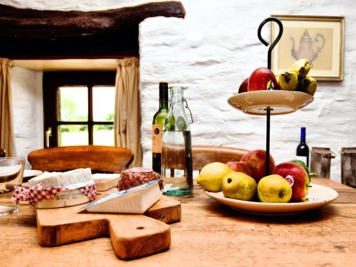a table with a plate of apples and pears on it at Romantic holiday house in the Ardennes in Nadrin