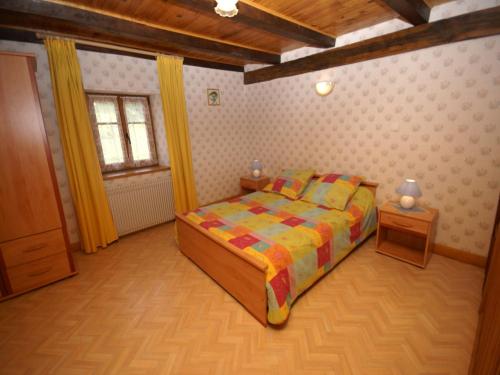a small bedroom with a bed and a window at Holiday Home in Esmoulières near Forest in Esmoulières