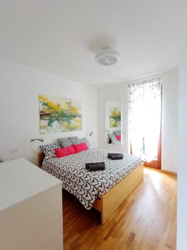 a bedroom with a bed with red pillows on it at Il Mirtillo Rosso - Anfo in Anfo
