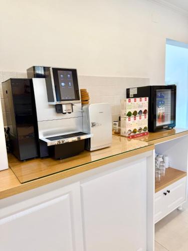 a counter with a coffee maker on top of it at Krystal Boutique Mansion in Hunedoara