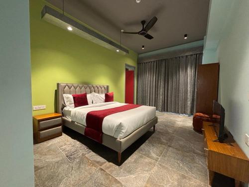 a bedroom with a bed and a flat screen tv at Cullinan Hotel & Restaurant in Bilāspur