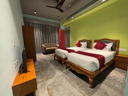 a bedroom with a bed and a television in it at Cullinan Hotel & Restaurant in Bilāspur
