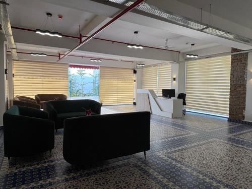 a lobby with couches and a desk in a building at Cullinan Hotel & Restaurant in Bilāspur