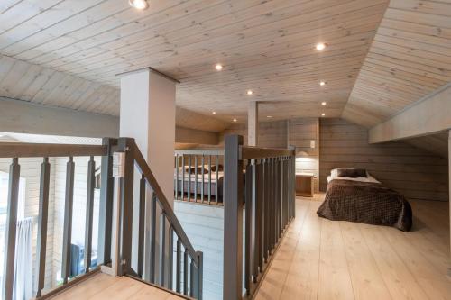 a bedroom with a bed in a room with wooden ceilings at Villa Peso 1&2 - 21 hlö, Both sides, HimosYkkösen alue in Jämsä