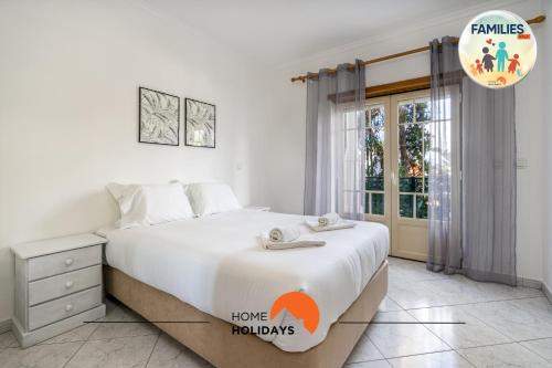 a bedroom with a large bed and a window at #230 Only Families - Flat A Flor by Home Holidays in Albufeira