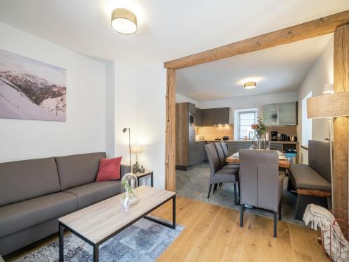 a living room with a couch and a table at Maisonette in Lungau near Ski Slopes in Sankt Michael im Lungau