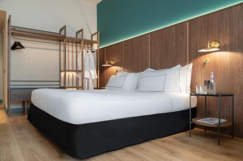 a large white bed in a hotel room at Meliá Milano in Milan