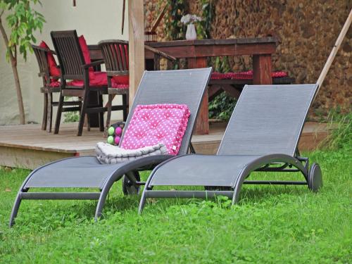 two chairs sitting in the grass in a yard at Pool Villa in Artigat Valley in Artigat