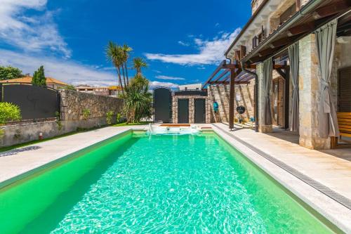 a swimming pool in the backyard of a house at Villa Fina in Malinska