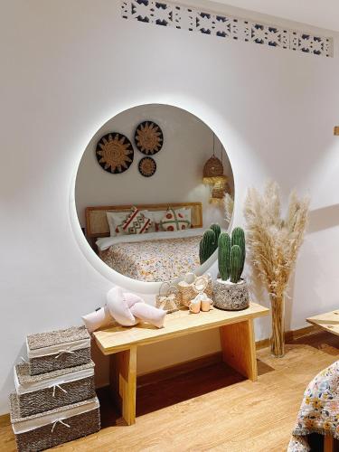 a bedroom with a bed and a round mirror at COCO HOUSE Bùi Thị Xuân, Đà Lạt in Da Lat