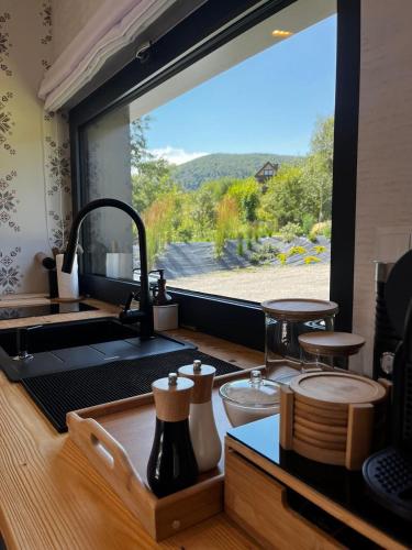 a kitchen with a sink and a large window at Yama Krywe in Krywe