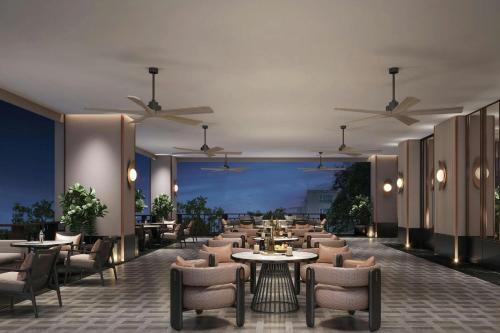 a restaurant with tables and chairs and ceilings at Chiang Mai Marriott Hotel in Chiang Mai