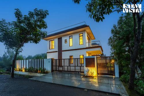a house with a gate in front of it at StayVista at Villa Alora with Jacuzzi in Lonavala
