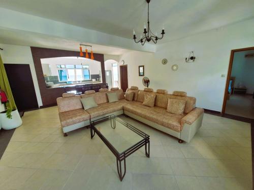 a living room with a couch and a table at Baywatch Apartment in La Gaulette