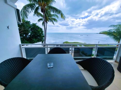 a table and chairs with a view of the ocean at Baywatch Apartment in La Gaulette