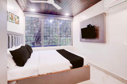 a bedroom with a bed and a window at Hotel Relax Residency in Mumbai