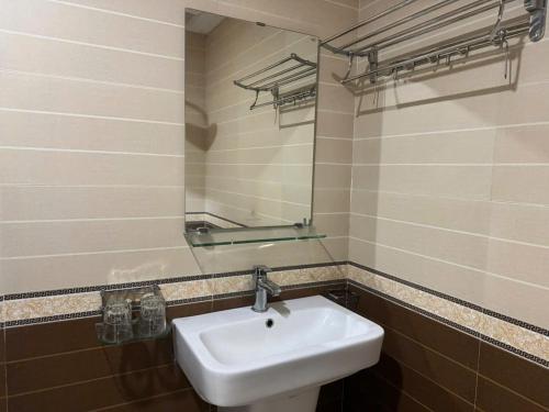 a bathroom with a sink and a mirror at Amlysa Sapa Hotel 2 in Sa Pa