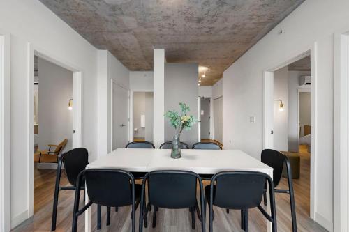 a dining room with a white table and chairs at Corporate-Friendly 4BR Stylish & Central in Chicago