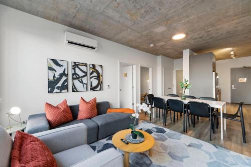 a living room with a couch and a table at Corporate-Friendly 4BR Stylish & Central in Chicago