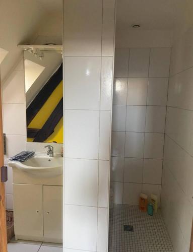 a bathroom with a sink and a mirror at Cœur de Loire in Nevers