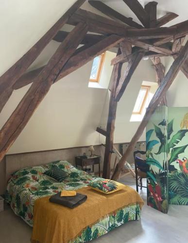 a bedroom with a bed in a attic at Cœur de Loire in Nevers