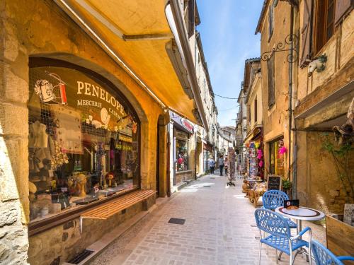 an alley in an old town with a table and chairs at Blanquefort Nature Stay in Saint-Cernin-de-lʼHerm