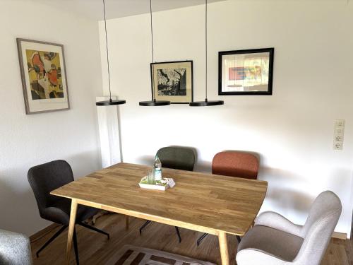a dining room with a wooden table and chairs at Ruheoase Inzell in Inzell
