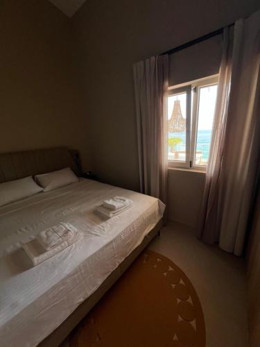 a bedroom with a bed and a large window at Villa Dottori in Kinira