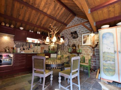 a kitchen with a table and chairs in it at Cottage near Bourtange with Hot Tub in Musselkanaal